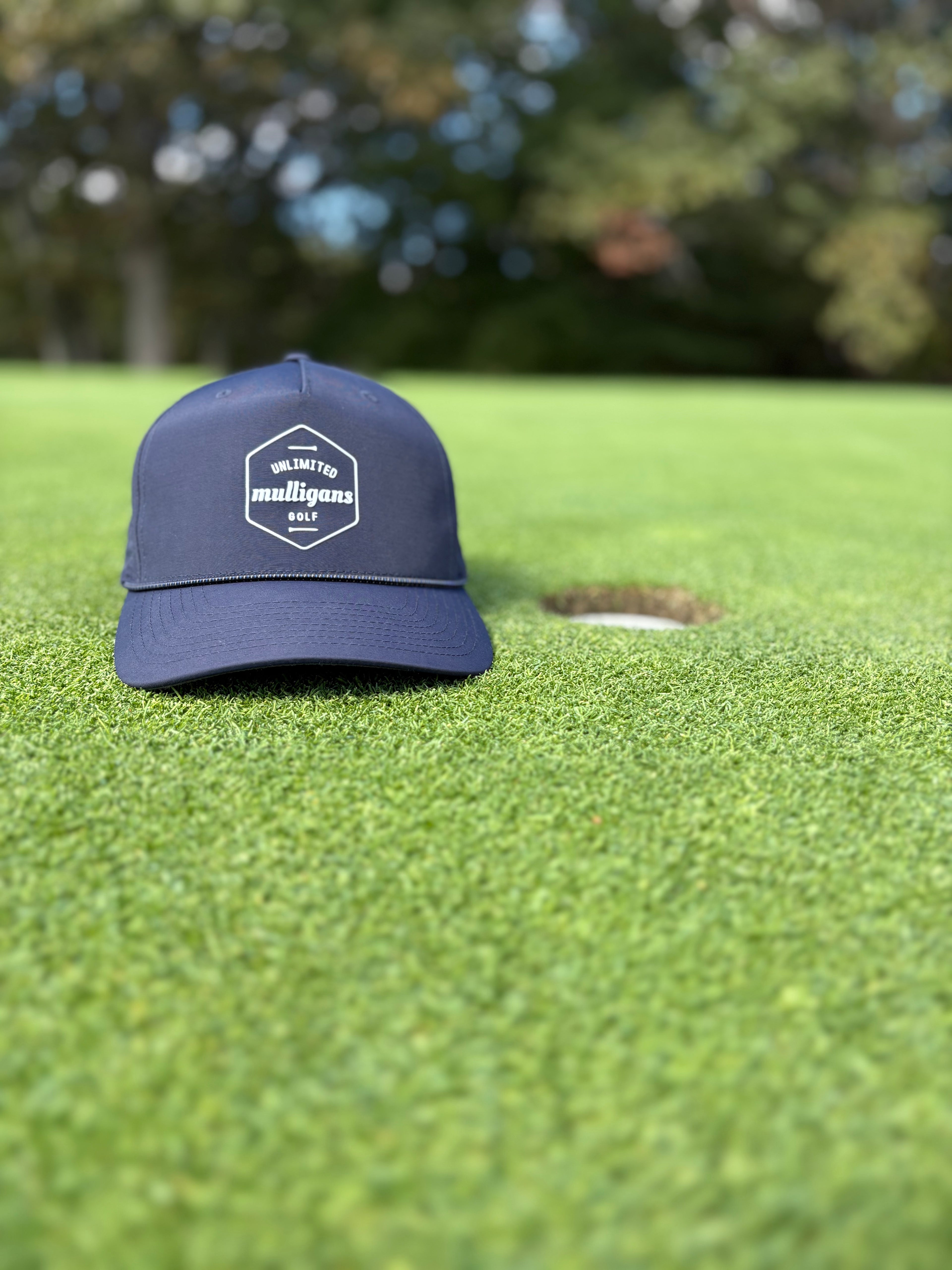 Blue cap with a logo on a green golf course